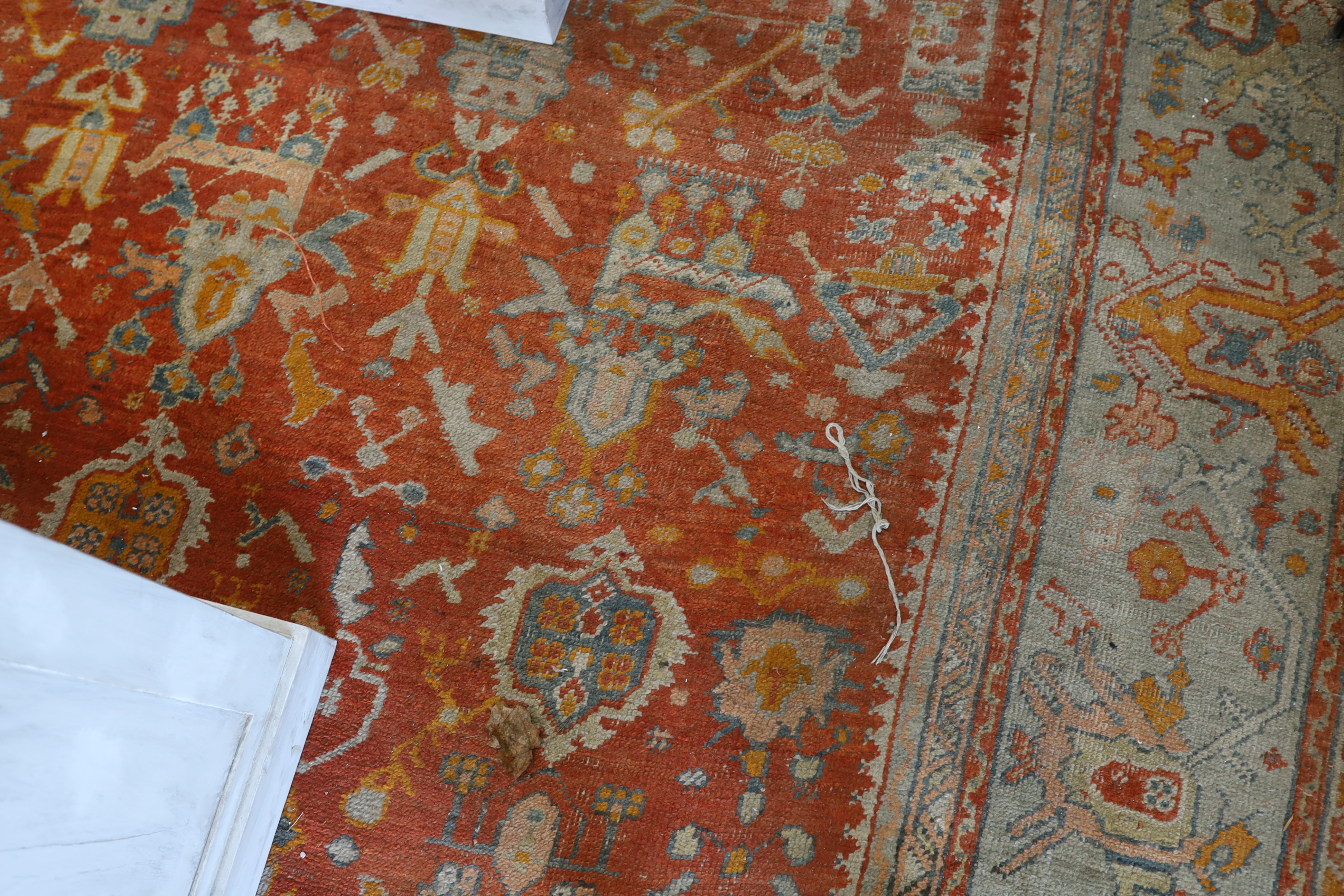 An Afghan red ground carpet, 395 x 310cm